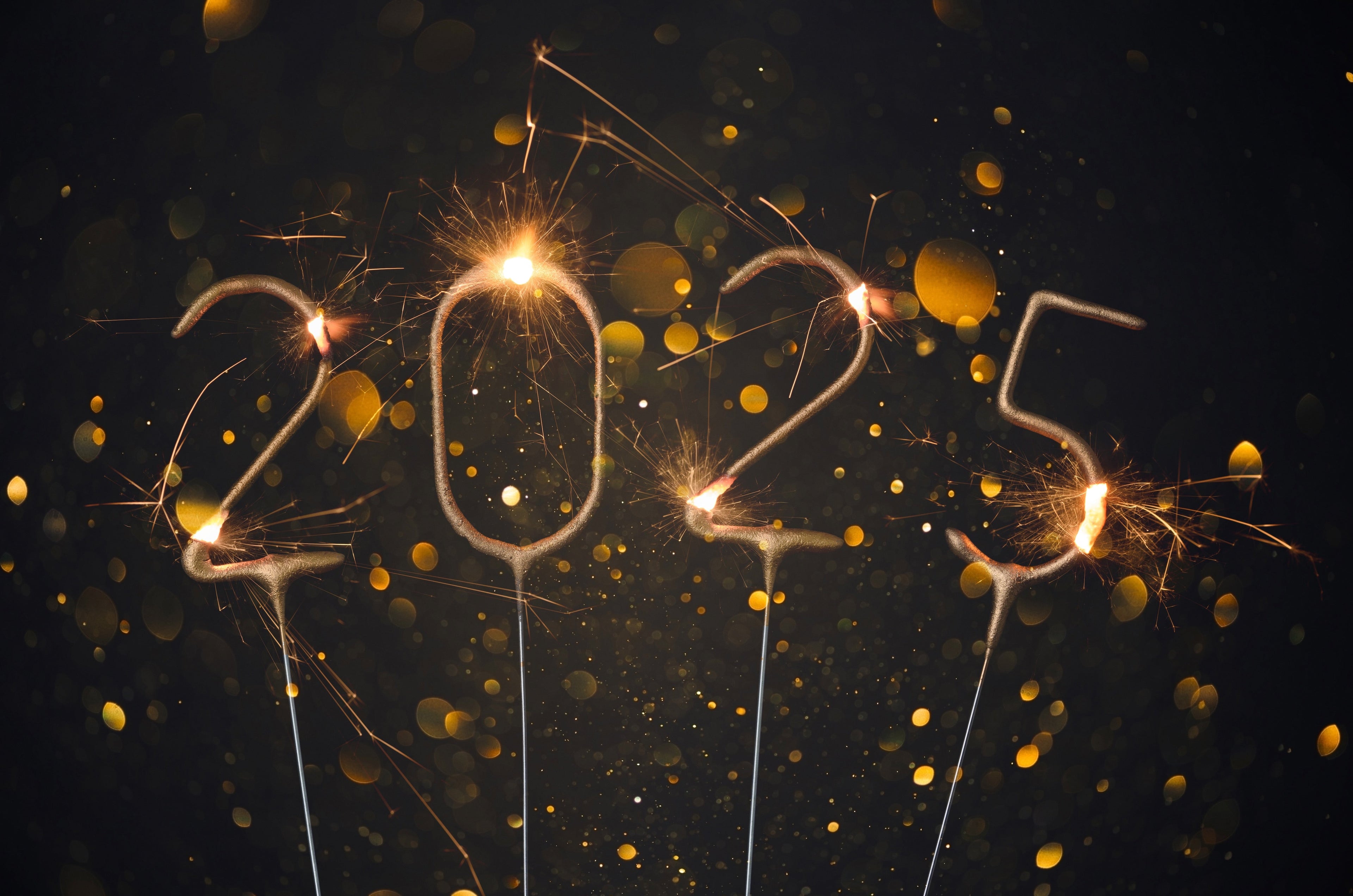 Glowing sparklers illuminate '2025 New Year's resolutions'